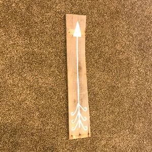 Wooden sign with white arrow